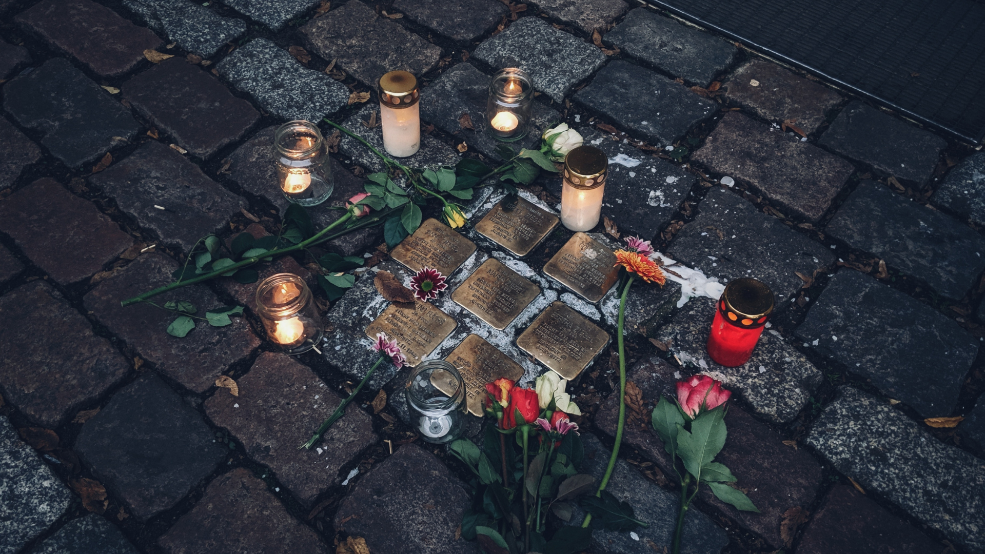 A Stolperstein inscribed with the name and life dates of victims of Nazi extermination or persecution in Berlin.